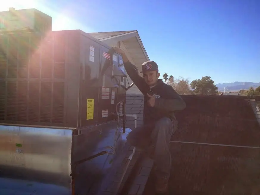 HVAC technician performing HVAC Inspection on a rooftop unit in Deerfield